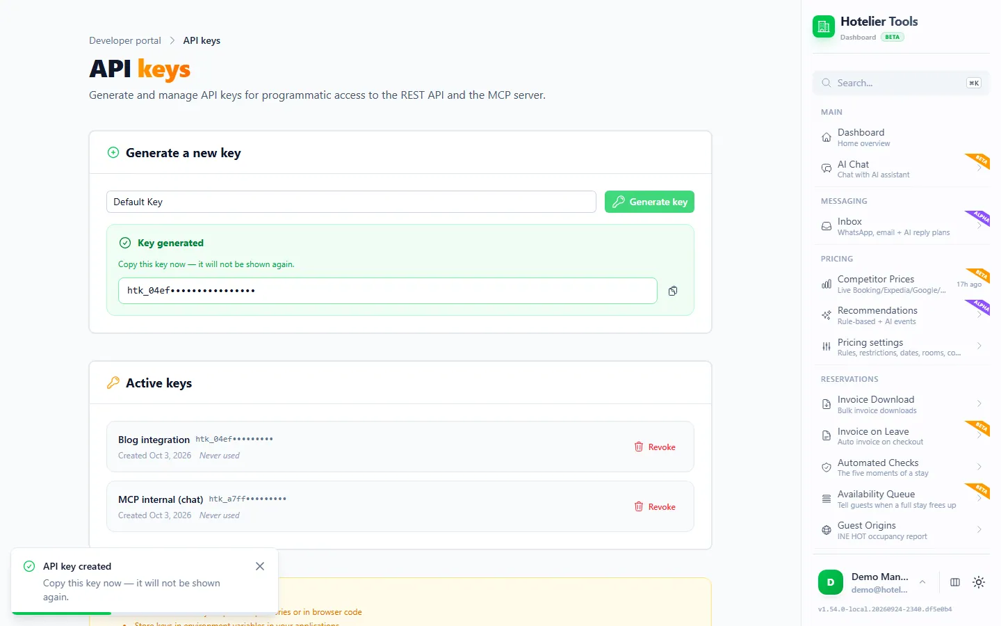Halaman API keys tepat setelah membuat key: kotak hijau Key generated dengan key sekali-tampil yang disamarkan dan tombol salin, key Blog integration yang baru di bawah Active keys dengan tombol Revoke, dan toast API key created